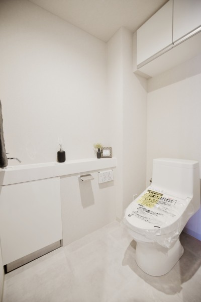 TOTO製ウォシュレット一体型のトイレです。手洗いカウンターもありますので、清潔に保てます。吊戸棚も設置していますので、小物類などもすっきりと収納出来ます。