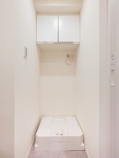 置場に困る洗濯用洗剤などを収納できる吊戸棚を造作しました。扉付きなので生活感を隠せるのも嬉しいポイント。新たにラックを設ける必要がなく、スタイリッシュな空間を維持できます。