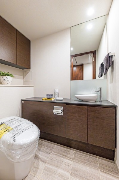 ゆったりとしたレストルームには洗練された住まいにふさわしいスタイリッシュなタンクレストイレを備え付けました。大きな鏡が設置され、収納にも便利な手洗いカウンター付きです。