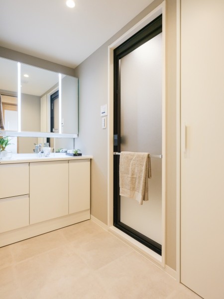 空間に美しく溶け込むスタイリッシュなデザインの洗面化粧台は、収納豊富な三面鏡タイプ。大きな鏡が印象的なラグジュアリーな空間です。