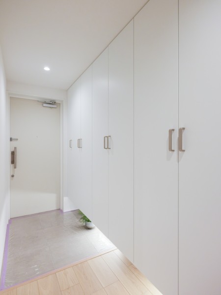 フットライトからのびる光が足元を優しく包み込む気品溢れる玄関です。天井までの高さのシューズボックスを豊富に備えたことで、玄関をすっきりとお使いいただけます。