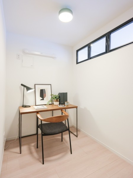 サービスルームとリビングを隔てる室内窓は、ブラックのフレームがスタイリッシュなデザインを採用しました。程よい光が注がれ、ワークスペースとしても活躍しそうです。