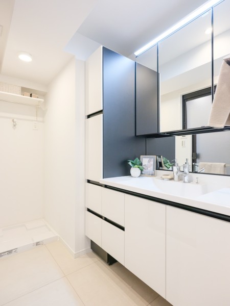 白を基調とした清潔感溢れるデザインのLIXIL製洗面化粧台です。化粧台横には、置場に困るタオルや着替え、ストック用品などを収納できるリネン庫を造作しました。