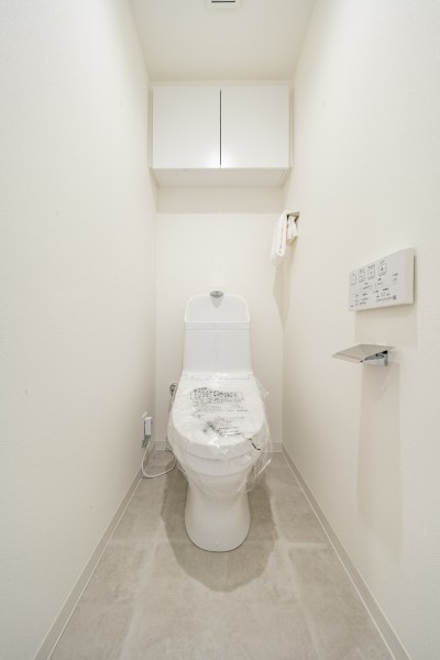 シンプルで安らぎが宿るレストルームです。吊戸棚を設け、掃除用品やペーパー類のストックがすっきりと収納いただけます。