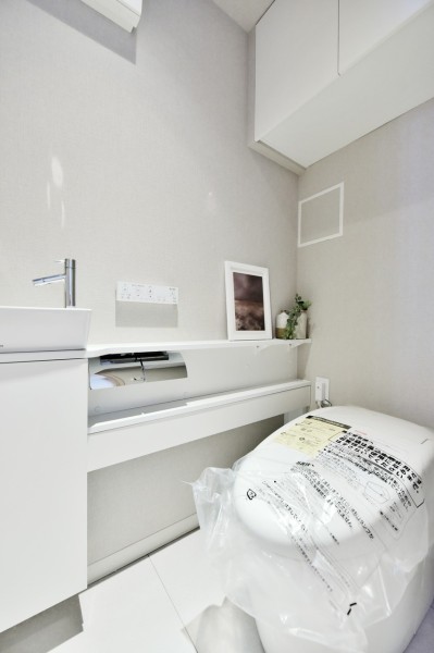 TOTO製ウォシュレット一体型タンクレストイレを採用しました。毎日使う場所だからこそシンプルで清潔感ある空間に仕上げました。吊戸棚を設置しましたので、小物類や清掃用品の収納にも便利です。