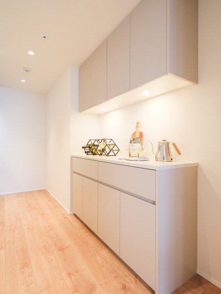 システムキッチンの背面にはお揃いのデザインのカップボードを造作いたしました。キッチンに吊戸棚や収納棚を設置し、カップボードにも複数の収納場所があります。お料理の導線を考えた収納をすることが可能です。