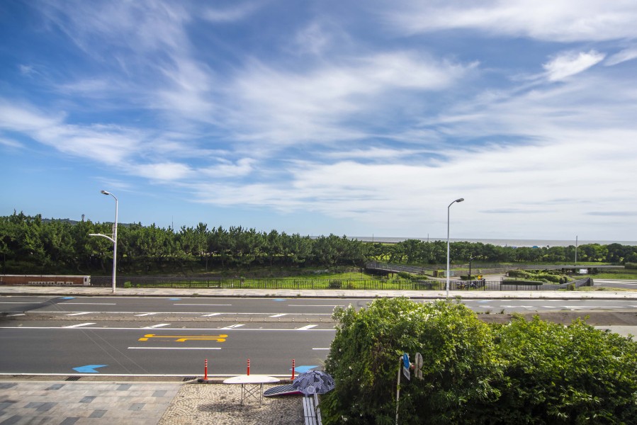 前面に建物がなく、青空と海がのぞく、ゆったりとした景色が広がっています。