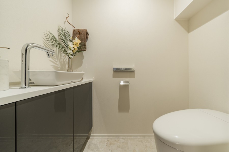 タンクレストイレやスティックリモコンでスタイリッシュな雰囲気を演出したレストルームです。毎日使う場所だからこそ、清潔感と使いやすさを考慮しました。
