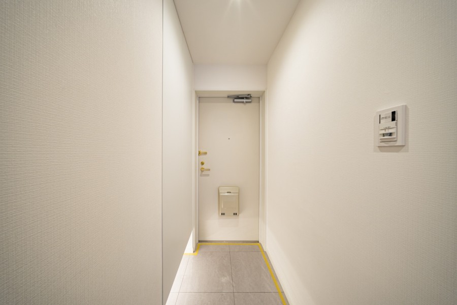 白を基調としたシンプルな設えが、住まい全体の上質さを予感させる玄関です。空間に浮かぶようなフットライトの光が、玄関に趣を添えています。