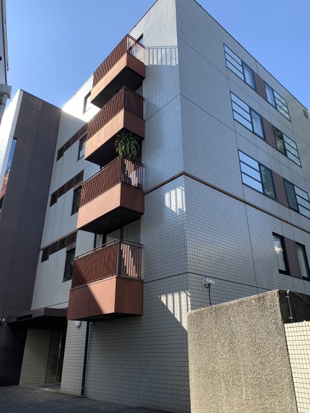 白金三光坂上の閑静な住宅街に佇む低層レジデンスです。タイル貼りの端正な外観と落ち着いた色調のバルコニーが街並みに調和し、洗練された佇まいを感じられます。