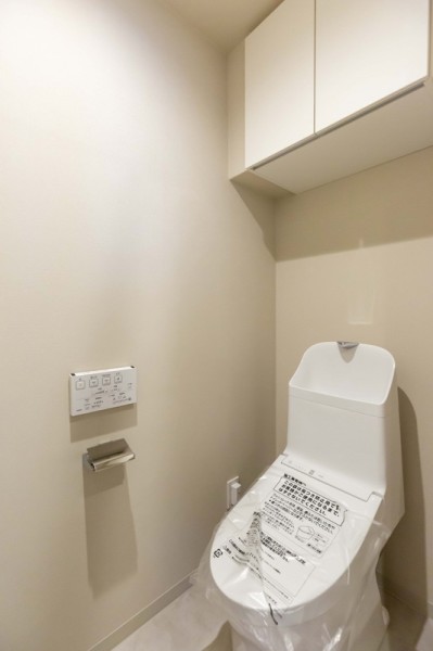 TOTO製洗浄便座付トイレを新規設置。トイレットペーパーなどの収納に便利な吊戸棚も備え付けです。