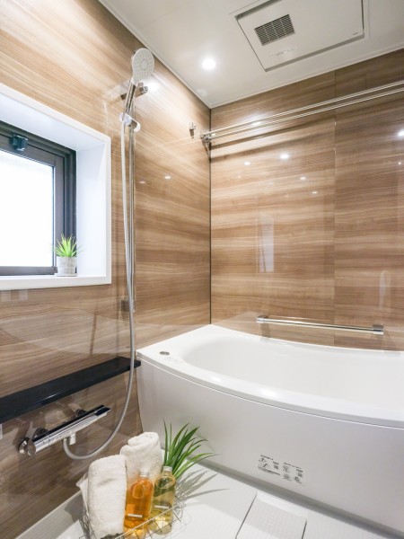 浴室にも窓があるので、自然光をとりこみ換気にも嬉しいバスルームです。光沢のある木目調のパネルが、より一層くつろぎの空間へ誘います。