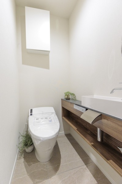 洗練されたお部屋にお似合いのスタイリッシュなタンクレストイレです。木の温もりを感じる手洗い場も備え付けました。