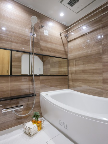 木目調パネルの光沢が美しい、ゆったりとおくつろぎいただけるバスルームです。美しいカーブと全身を包み込むような入浴感が特長の浴槽です。