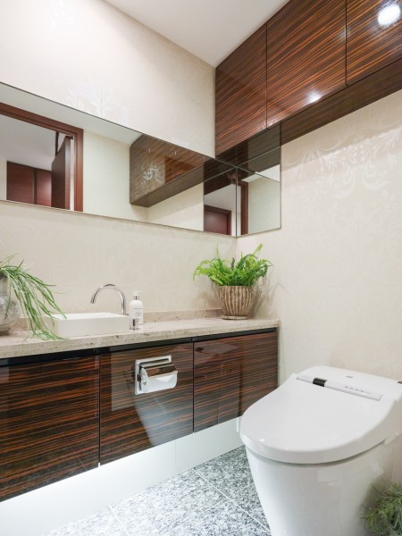 手洗い場付きのレストルームには、スタイリッシュなタンクレストイレを採用しています。大きな鏡があり、ちょっとした身だしなみチェックにも便利で実用的な空間です。
