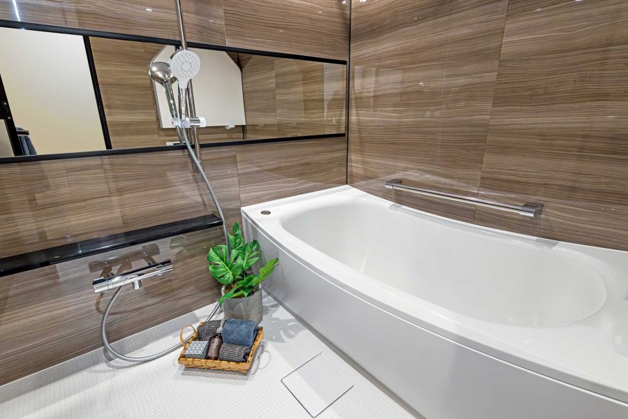 美しいカーブと全身を包み込むような入浴感が特長の浴槽や光沢感のある木目調パネルによって、より一層くつろぎの空間が演出されるバスルームです。