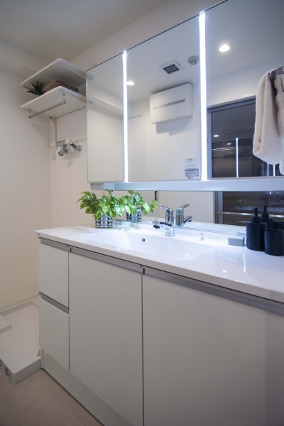 身支度の時間をも快適に彩る、美しく空間に溶け込む洗面化粧台です。洗濯機置場の上には可動式で便利な棚を備え付けました。