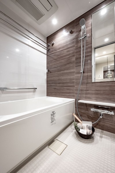 光沢のある木目調パネルが高級感を漂わせるバスルームです。都会の喧騒を忘れて、癒しの時間を満喫することができます。