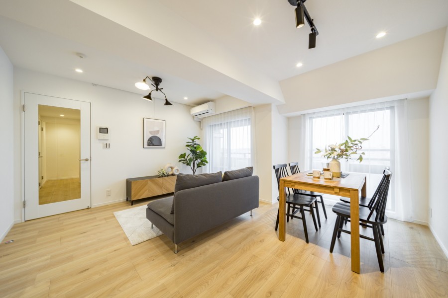 バルコニーへと続く大きな開口部が、室内に奥行きと開放感をプラスします。カーテン越しに広がる柔らかな光が、穏やかでくつろぎの空間を演出します。