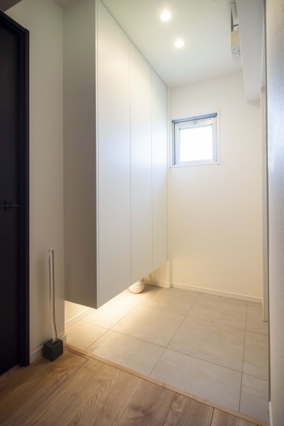 玄関扉を開けた瞬間に広がるのは、明るく清々しい玄関スペースです。小窓から差し込む光が、温かみのある木目調の建具と美しく調和し、住まう方を優しく迎え入れます。